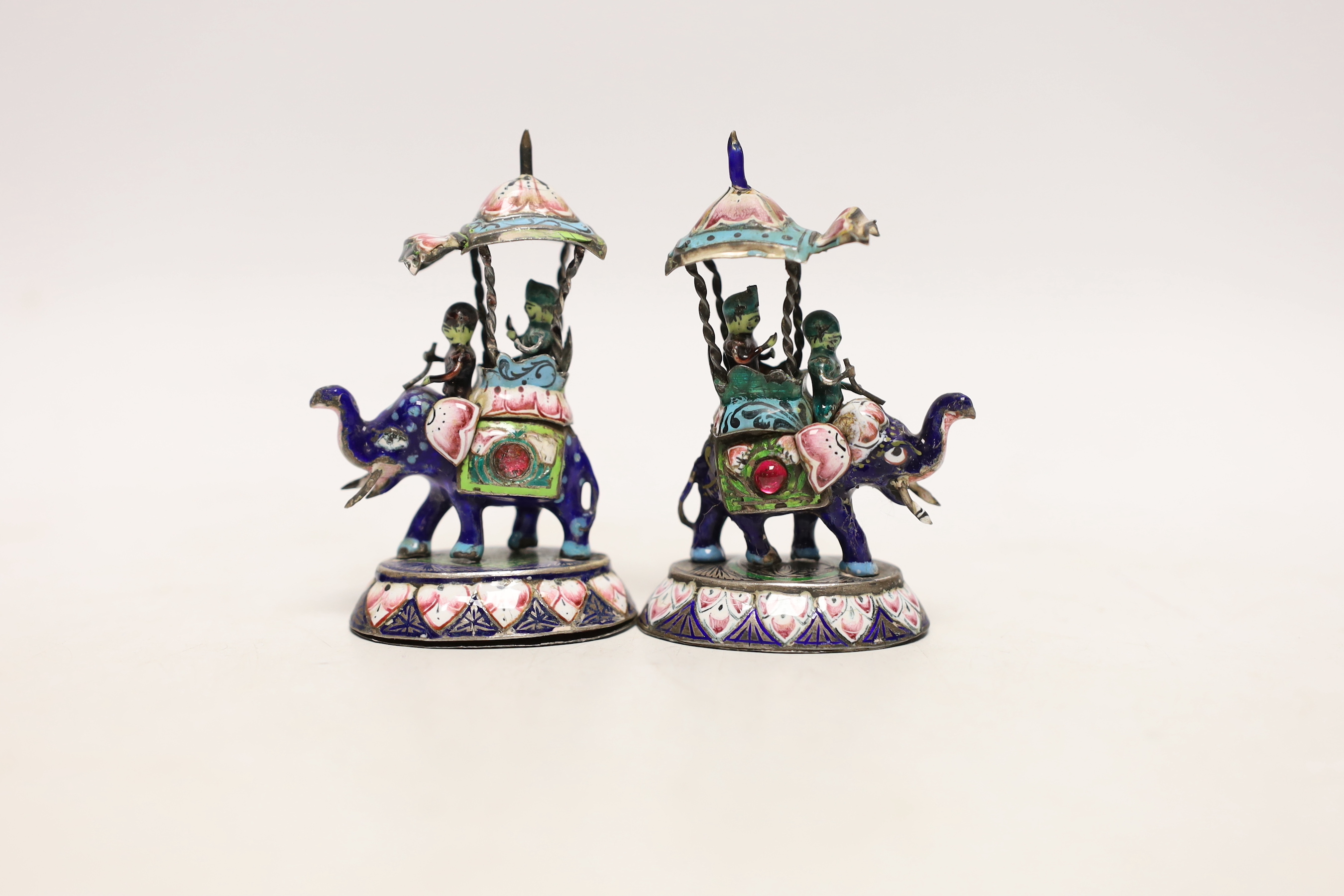 A pair of Indian gilt white metal and polychrome enamel elephants with howdahs, height 77mm.